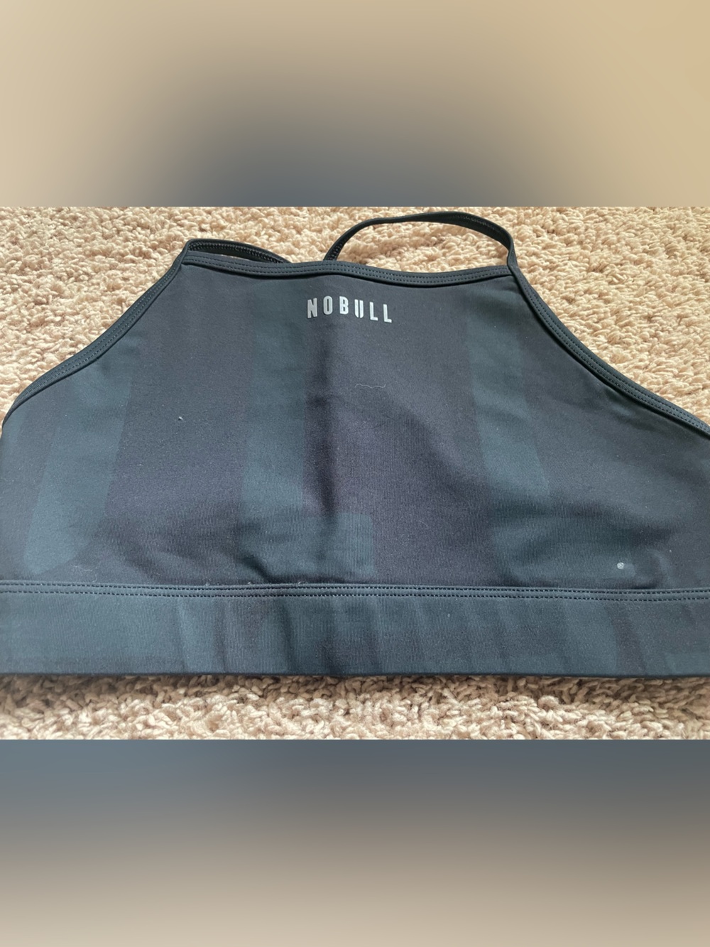 NOBULL Black Sports Bra with NOBULL logo faintly displayed.